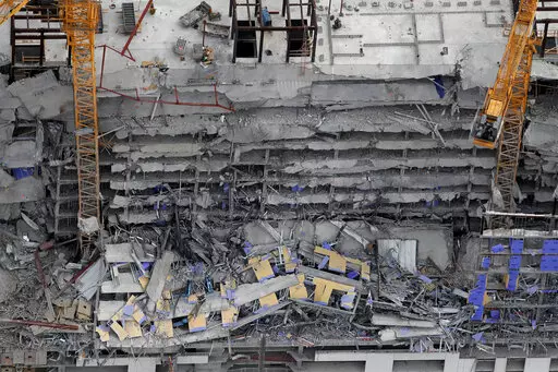 This aerial photo shows the Hard Rock Hotel, which was under construction, after a fatal partial collapse in New Orleans on Oct. 12, 2019. A New Orleans judge has brought in a mediator to try to work out a settlement with hundreds of people who claim damage from the hotel construction collapse nearly three years ago. Plaintiffs say they were injured, a loved one killed, or their business damaged when upper stories of the planned Hard Rock Hotel collapsed. (AP Photo/Gerald Herbert, File)