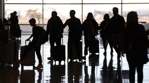 People pass through Salt Lake City International Airport Wednesday, Jan. 11, 2023, in Salt Lake City. Summer can be an expensive time to travel. Though it’s usually best to pay with cash for any nonessentials, like a vacation, there are financing options available if you don’t have the funds to cover your travel expenses outright. (AP Photo/Rick Bowmer, File)