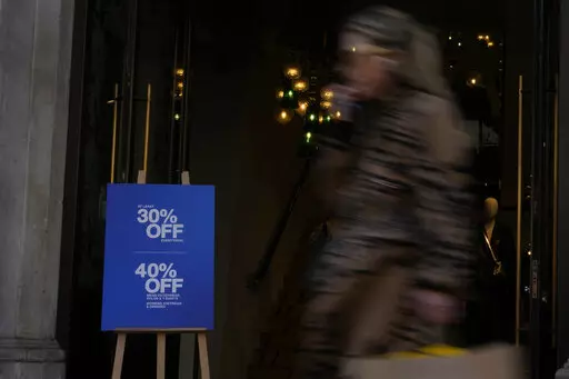 A woman passes by a clothing chain advertising a sale on Regent Street in London, Wednesday, Nov. 16, 2022. Britain's inflation rate rose to a 41-year high in October, fueling demands for the government to do more to ease the nation's cost-of-living crisis when it releases new tax and spending plans on Thursday. The Office for National Statistics says consumer prices rose 11.1% in the 12 months through October, compared with 10.1% in September. The October figure exceeded economists expectations