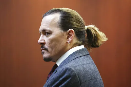 Actor Johnny Depp arrives in the courtroom at the Fairfax County Circuit Court in Fairfax, Va., Thursday, April 28, 2022. Actor Johnny Depp sued his ex-wife actor Amber Heard for libel in Fairfax County Circuit Court after she wrote an op-ed piece in The Washington Post in 2018 referring to herself as a "public figure representing domestic abuse." (Michael Reynolds/Pool Photo via AP)
