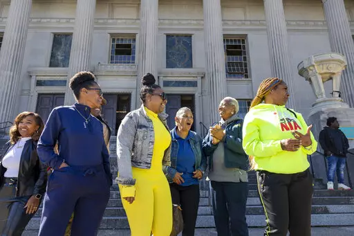 Family members of Leroy Nelson, Bernell Juluke, and Kunta Gable smile as they stand outside Orleans Parish Criminal District Court in New Orleans after the three men, convicted for a 1990s crime, were ordered freed on Wednesday, Oct. 18, 2022, in part because of the role former officer and convicted killer Len Davis played in the investigation. Prosecutors joined defense lawyers in seeking to have their convictions thrown out. The women said they were going straight from the courthouse to Angola