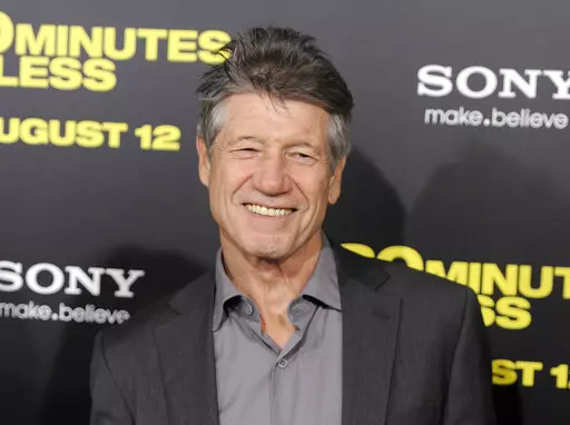 Fred Ward, a cast member in "30 Minutes or Less," poses at the premiere of the film in Los Angeles on Aug. 8, 2011. Ward, a veteran actor who brought a gruff tenderness to tough-guy roles in such films as “The Right Stuff,” “The Player” and “Tremors,” died Sunday, May 8, his publicist Ron Hofmann said Friday, May 13, 2022. He was 79. (AP Photo/Chris Pizzello, File)