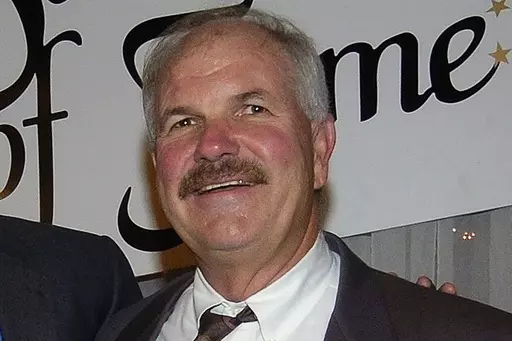 Former New Orleans Saints defensive coordinator Steve Sidwell poses for a photograph after being inducted into the New Orleans Saints Hall of Fame, Friday Nov. 12, 2004, in Metairie, La. Sidwell, who coached the famed “Dome Patrol” linebacker corps and help construct some of the top defenses in franchise history, died Wednesday, Aug. 23, 2023, at age 78. (AP Photo/Bill Haber, File)