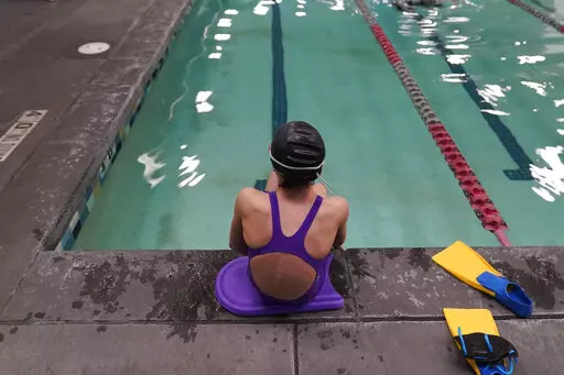 A proposed ban on transgender athletes playing female school sports in Utah would affect transgender girls like this 12-year-old swimmer seen at a pool in Utah on Feb. 22, 2021. She and her family spoke with The Associated Press on the condition of anonymity to avoid outing her publicly. She cried when she heard about the proposal that would ban transgender girls from competing on girls' sports teams in public high schools, which would separate her from her friends. Republican governors of two s