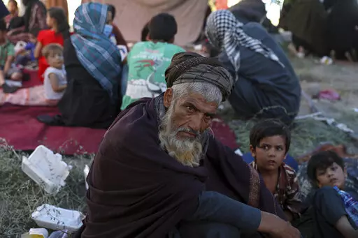 FILE- Internally displaced Afghans from northern provinces, who fled their home due to fighting between the Taliban and Afghan security personnel, take refuge in a public park in Kabul, Afghanistan, Monday, Aug. 9, 2021. Afghanistan is the unhappiest country in the world — even before the Taliban swept to power last August. That's according to a so-called World Happiness report released, Saturday, March 19, 2022 ahead of the U.N.-designated International Day of Happiness on Sunday.  (AP Photo/