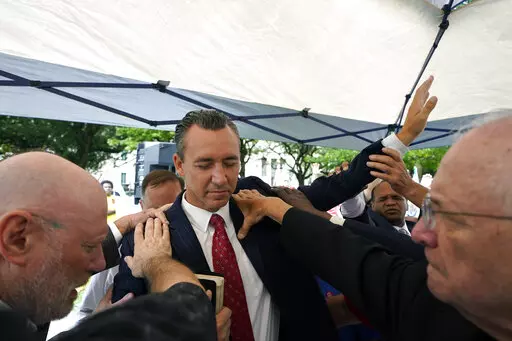 Tony Spell, pastor of the Life Tabernacle Church of Central City, La., prays with supporters outside the Fifth Circuit Court of Appeals in New Orleans on June 7, 2021.  An outspoken Christian conservative attorney from Alabama has asked a federal appeals court to revive the Louisiana pastor’s damage claims against state officials over long-expired COVID-19 restrictions.  A federal judge had earlier this year dismissed minister Spell’s lawsuit against Gov. John Bel Edwards and others over enf