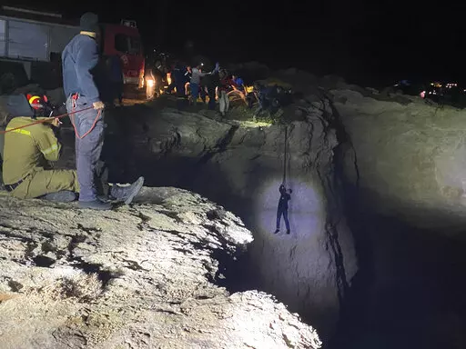 Authorities and local residents save a migrant during a large-scale rescue operation on the island of Kythira, some 225 kilometers (140 miles) south of Athens, early Thursday, Oct. 6, 2022. The operation is underway off a southern Greek island where a sailboat carrying up to 100 migrants sank in high winds. The coast guard said its vessels, private boats and a rescue helicopter were involved in the effort off the coast of the island of Kythira. (Ippolytos Prekas/kythera.news via AP)