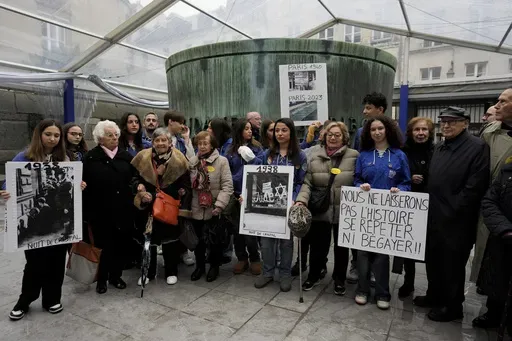 French nazi hunter Serge Klarsfeld, right, his wife Beata, second from right, French Holocaust survivors, Edith Senot, third from left, and Ginette Kolinka, fifth from left, attend a gathering in the Paris Holocaust memorial to sound the alarm about resurgent antisemitic hate speech, graffiti and abuse linked to the Israel-Hamas war, in Paris, Saturday, Nov. 18, 2023. rance's Interior Ministry said this week that 1,762 antisemitic acts have been reported this year, as well as 131 anti-Muslim act