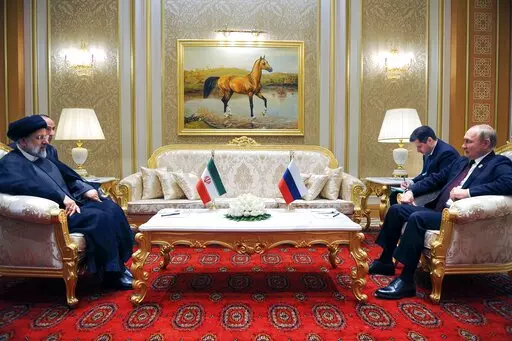 Russian President Vladimir Putin, right, speaks to Iran's President Ebrahim Raisi on the sideline of the summit of Caspian Sea littoral states in Ashgabat, Turkmenistan, Wednesday, June 29, 2022. (Mikhail Klimentyev, Sputnik, Kremlin Pool Photo via AP, File)