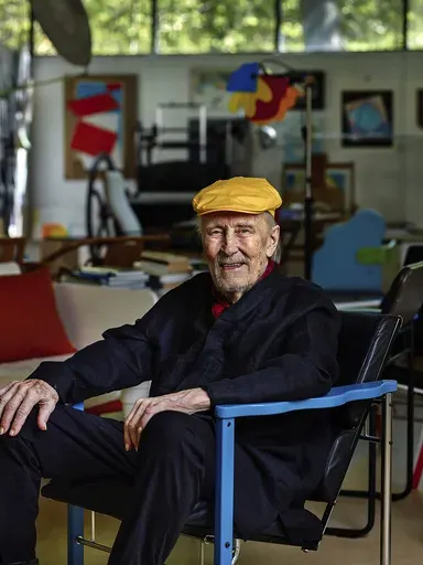 This undated image provided by Studio Kukkapuro shows Yrjö Kukkapuro, a renowned Finnish furniture designer whose postmodern style of chairs graced waiting rooms and museums alike, sitting in his famous Experimental chair in his studio outside Helsinki. (Studio Kukkapuro via AP)
