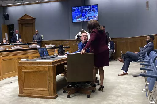 Louisiana State Police Lt. Col. Doug Cain, the agency’s second in command, confers with Gail Holland, a Louisiana State Police attorney,  while testifying Tuesday, March 22, 2022,  in Baton Rouge, La., before a legislative panel conducting an "all-levels" probe into the fatal 2019 arrest of Black motorist Ronald Greene. (AP Photo/Jim Mustian)