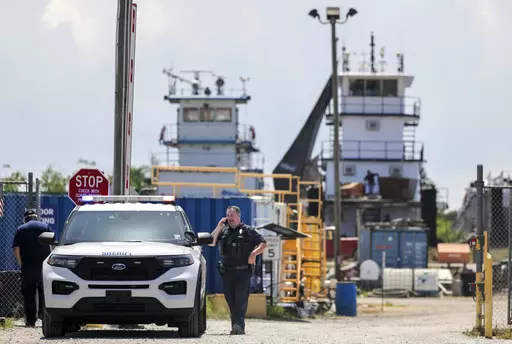 A Jefferson Parish sheriff's deputy is seen at FMT Shipyard and Repair after two employees were shot and killed in Harvey, La., Monday, July 17, 2023. (Brett Duke/The Times-Picayune/The New Orleans Advocate via AP)