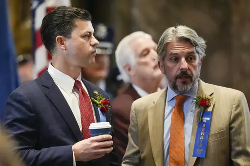 Republican state Sen. Jeremy Stine, left, talks with Senate president Cameron Henry before the swearing in of the Louisiana state legislature in Baton Rouge, La., Monday, Jan. 8, 2024. (AP Photo/Gerald Herbert, Pool)