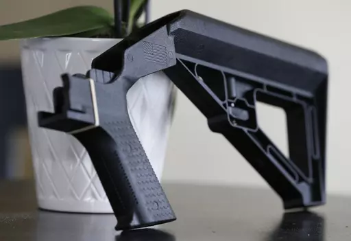 A bump stock is displayed in Harrisonburg, Va., on March 15, 2019. The Supreme Court will hear a challenge Wednesday, Feb. 28, to a Trump-era ban on bump stocks, a gun accessory used in a Las Vegas massacre that was the deadliest mass shooting in modern U.S. history. (AP Photo/Steve Helber, File)