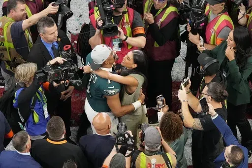 Philadelphia Eagles quarterback Jalen Hurts (1) hugs his partner Bryonna Burrows after the NFL Super Bowl 59 football game against the Kansas City Chiefs, Sunday, Feb. 9, 2025, in New Orleans. (AP Photo/Godofredo A. Vasquez)