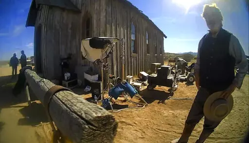 In this image from video released by the Santa Fe County Sheriff's Office, Alec Baldwin stands in costume and speaks with investigators following a fatal shooting last year on a movie set in Santa Fe, N.M. On Friday, Nov. 11, 2022, Alec Baldwin sued people involved in handling and supplying the loaded gun that he was using when it fired, killing cinematographer Halyna Hutchins during the 2021 filming accident. (Santa Fe County Sheriff's Office via AP, File)