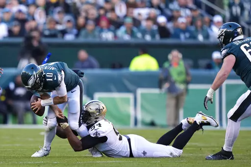 Philadelphia Eagles quarterback Gardner Minshew (10) is sacked by New Orleans Saints defensive end Cameron Jordan (94) in the second half of an NFL football game in Philadelphia, Sunday, Jan. 1, 2023. (AP Photo/Matt Slocum)
