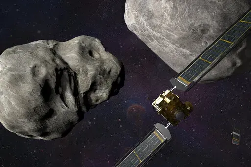This illustration made available by Johns Hopkins APL and NASA depicts NASA's DART probe, foreground right, and Italian Space Agency's (ASI) LICIACube, bottom right, at the Didymos system before impact with the asteroid Dimorphos, left. DART is expected to zero in on the asteroid Monday, Sept. 26, 2022, intent on slamming it head-on at 14,000 mph. The impact should be just enough to nudge the asteroid into a slightly tighter orbit around its companion space rock. (Steve Gribben/Johns Hopkins APL