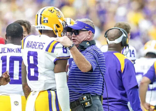 LSU head coach Brian Kelly talks with Malik Nabers on the sideline during an NCAA college football game against Mississippi in Baton Rouge, La., Saturday, October 22, 2022/The Daily Advertiser via AP)