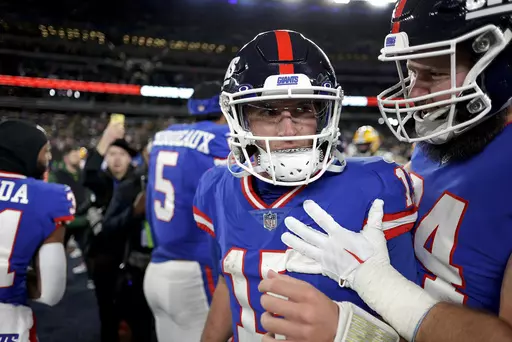 New York Giants quarterback Tommy DeVito (15) celebrates on the field with teammates after playing against the Green Bay Packers in an NFL football game, Monday, Dec. 11, 2023, in East Rutherford, N.J. (AP Photo/Adam Hunger)