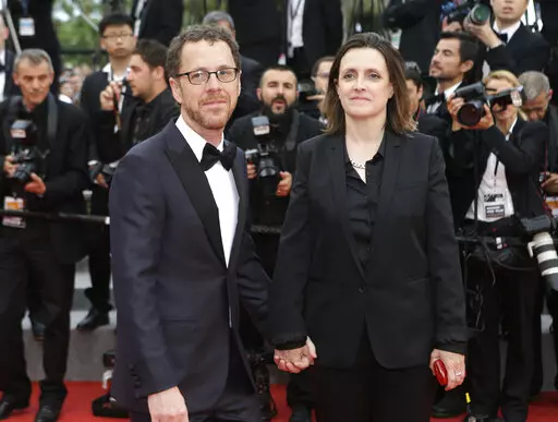 Ethan Coen, left, and Tricia Cooke at the 68th international film festival, Cannes, southern France, Saturday, May 23, 2015. Most in the film industry thought Ethan Coen was done with movies. Ethan did, too. But on Sunday, Coen will premiere his first documentary, "Jerry Lee Lewis: Trouble in Mind," at the Cannes Film Festival. (AP Photo/Lionel Cironneau, File)