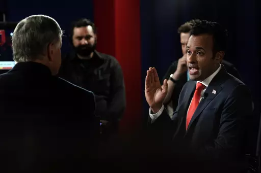 Businessman Vivek Ramaswamy talks with Sean Hannity in the spin room after a Republican presidential primary debate hosted by FOX News Channel Wednesday, Aug. 23, 2023, in Milwaukee. (AP Photo/Morry Gash)