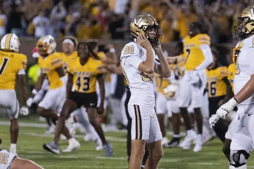 Missouri celebrates behind Vanderbilt place kicker Brock Taylor (88) after he missed a field goal during overtime of an NCAA college football game as Missouri celebrates Saturday, Sept. 21, 2024, in Columbia, Mo. (AP Photo/L.G. Patterson)