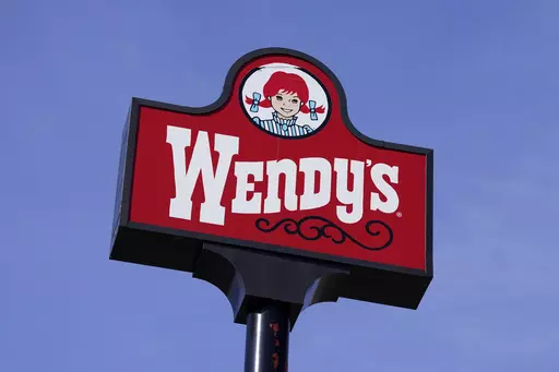 A sign stands over a Wendy's restaurant, Feb. 25, 2021, in Des Moines, Iowa. Wendy’s says that it has no plans to increase prices during the busiest times at its restaurants, Wednesday, Feb. 28, 2024. The burger chain clarified its stance on how it will approach pricing after various media reports said that the company was looking to test having the prices of its menu items fluctuate throughout the day based on demand. (AP Photo/Charlie Neibergall, File)