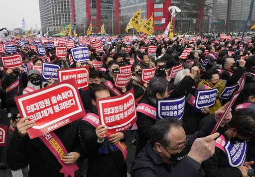 Doctors stage a rally against the government's medical policy in Seoul, South Korea, on March 3, 2024. South Korean authorities have suspended the licenses of two senior doctors for allegedly inciting the weekslong walkouts by medical interns and residents that disrupted hospital operations across the country. That's according to one of the doctors who spoke to The Associated Press. The suspensions are the government’s first punitive step against physicians after thousands of doctors-in-traini