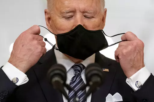 President Joe Biden takes off his mask to speak about the COVID-19 pandemic during a prime-time address from the East Room of the White House, on March 11, 2021, in Washington. (AP Photo/Andrew Harnik, File)