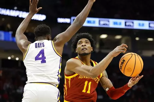 Iowa State's Tyrese Hunter shoots past LSU's Darius Days during the first half of a first round NCAA college basketball tournament game Friday, March 18, 2022, in Milwaukee. (AP Photo/Jeffrey Phelps)
