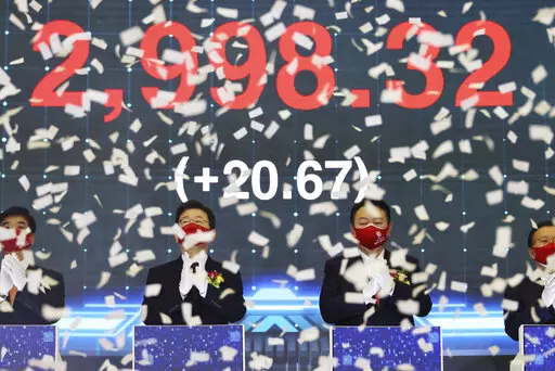 Yoon Suk Yeol, center right, the presidential election candidate of South Korea's main opposition People Power Party (PPP), and Lee Jae-myung, center left, the presidential election candidate of the ruling Democratic Party, attend a ceremony for the first trading day of stock market at the Korea Exchange (KRX) in Seoul, South Korea Monday, Jan. 3, 2022. (Kim Hong-ji/Pool Photo via AP)