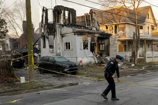 Law enforcement stand outside a home in East Lansdowne, Pa., Thursday morning, Feb. 8, 2024, where several members of a family are unaccounted for following a fire and the shooting of two police officers on Wednesday. The nation is witnessing the second-highest number on record of mass killings and deaths to this point in a single year. Only 2023 had more, with six mass killings and 39 deaths at this point last year. (Tom Gralish/The Philadelphia Inquirer via AP, File)