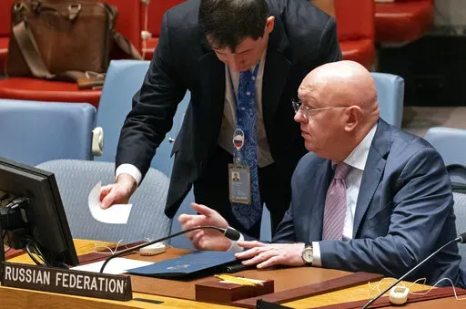Russian Ambassador to the United Nations Vasily Nebenzya, seated, speaks with Dmitry Polyanskiy, First Deputy Permanent Representative of the Russian Federation, just before Nebenzya addressed the Security Council during a session to discuss the situation with grain shipments from Ukraine at United Nations headquarters, Monday, Oct. 31, 2022. (AP Photo/Craig Ruttle)