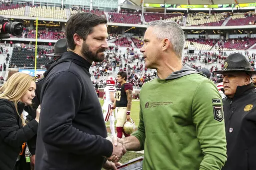 Louisiana head coach Michael Desormeaux and Florida State head coach Mike Norvell, right, shake hands after an NCAA college football game on Saturday, Nov. 19, 2022, in Tallahassee, Fla. Florida State defeated Louisiana 49-17. (AP Photo/Gary McCullough)