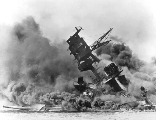 In this photo provided by the U.S. Navy, smoke rises from the battleship USS Arizona as it sinks during the Japanese attack on Pearl Harbor, Hawaii, Dec. 7, 1941. The U.S. Navy and the National Park Service will host a remembrance ceremony at Pearl Harbor in December 2022, the 81st anniversary of the 1941 Japanese bombing. (AP Photo/File)