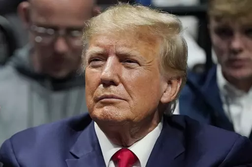 Former President Donald J. Trump watches the NCAA Wrestling Championships, Saturday, March 18, 2023, in Tulsa, Okla. Trump’s calls for protests ahead of his anticipated indictment in New York have generated mostly muted reactions from supporters, with even some of his most ardent loyalists dismissing the idea as a waste of time or a law enforcement trap. (AP Photo/Sue Ogrocki, File)