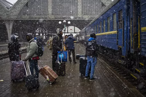 Nigeria students in Ukraine wait at the platform in Lviv railway station, Feb. 27, 2022, in Lviv, west Ukraine. Jarred by discriminatory treatment and left to evacuate themselves from Ukraine, people from African, Asian and Latin American countries who succeed in getting out are forming impromptu networks to help thousands of others hoping to flee. (AP Photo/Bernat Armangue, File)