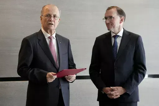 Prime Minister of the Palestinian Authority Mohammed Mustafa, left, speaks after receiving a document handed over by Norway's Foreign Minister Espen Barth Eide, right, prior to a meeting for talks on the Middle East in Brussels, Sunday, May 26, 2024. Norway on Sunday handed over papers to the Palestinian prime minister to officially give it diplomatic recognition as a state in a largely symbolic move that has infuriated Israel. The formal recognition by Norway, Spain and Ireland, which all have 