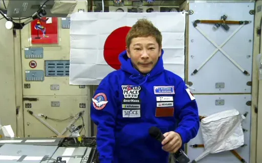 Japanese space tourist Yusaku Maezawa speaks during an interview with The Associated Press from the International Space Station, ISS, Monday, Dec. 13, 2021. Maezawa said he experienced motion sickness after arriving at the space outpost and it took him a few days to adapt to zero gravity. (Roscosmos Space Agency via AP)
