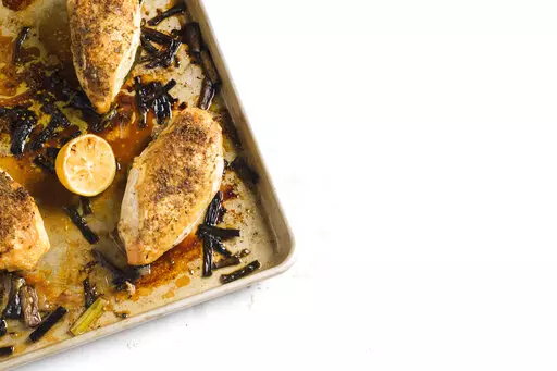 This image released by Milk Street shows a recipe for Fennel-Crusted Chicken & Scallion Traybake. (Milk Street via AP)