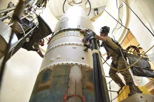 In this image provided by the U.S. Air Force, Airman 1st Class Jackson Ligon, left, and Senior Airman Jonathan Marinaccio, 341st Missile Maintenance Squadron technicians, connect a re-entry system to a spacer on an intercontinental ballistic missile during a Simulated Electronic Launch-Minuteman test Sept. 22, 2020, at a launch facility near Malmstrom Air Force Base in Great Falls, Mont. The Air Force says a review of a Montana nuclear missile base where an unusual number of troops have reported