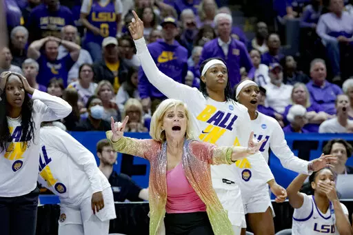 LSU head coach Kim Mulkey, center front, reacts to a call during the second half of a women's college basketball game against Ohio State in the second round of the NCAA tournament, Monday, March 21, 2022, in Baton Rouge, La. (AP Photo/Matthew Hinton)