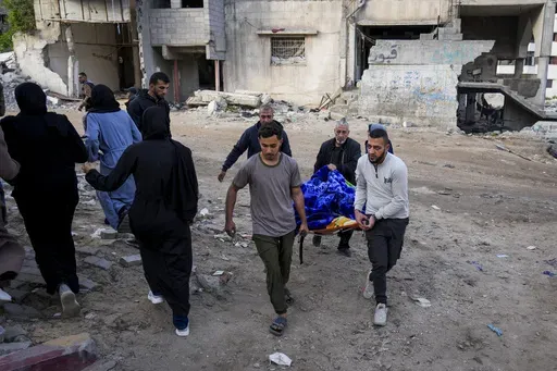 The body of a Palestinian killed in an Israeli army airstrikes is brought to Shifa Hospital in Gaza City, Tuesday, March 18, 2025. (AP Photo/Abdel Kareem Hana)