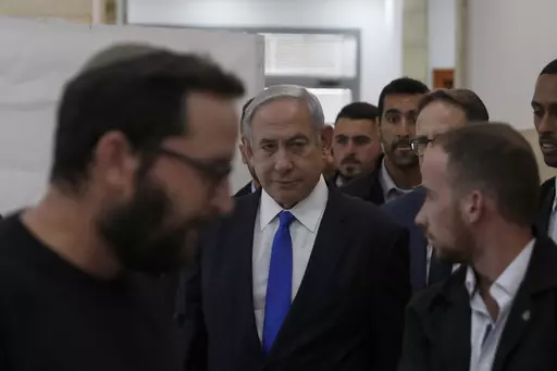 Israeli Prime Minister Benjamin Netanyahu, center, arrives at the District Court in Jerusalem, Israel, Sunday, June 25, 2023. Hollywood producer Arnon Milchan was testifying Sunday at Netanyahu’s corruption trial to answer questions about an alleged “supply line” of champagne and cigars funneled to the Israeli leader and his wife said to have been in exchange for help with Milchan’s personal and business needs. Milchan appeared by videoconference from the English city of Brighton. (Atef 