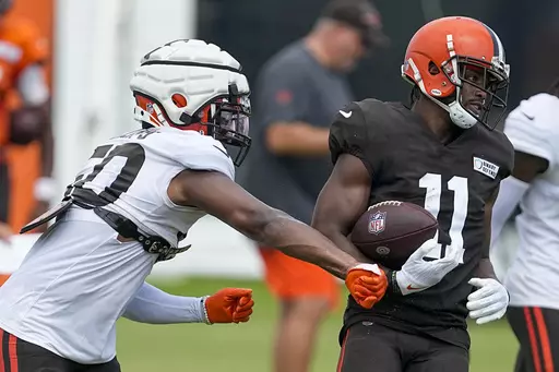 Cleveland Browns' Jacob Phillips knocks the ball away from Donovan Peoples-Jones during drills at the NFL football team's training camp on Saturday, July 29, 2023, in White Sulphur Springs, W.Va. (AP Photo/Chris Carlson)