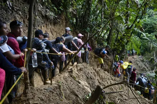 Migrants, mostly Venezuelans, walk across the Darien Gap from Colombia into Panama, hoping to reach the U.S., Oct. 15, 2022. Refugee agency UNHCR estimates more than 7.7 million Venezuelans have left since 2014, the largest exodus in Latin America’s recent history, with most settling in the Americas, from neighboring Colombia and Brazil to Argentina and Canada. (AP Photo/Fernando Vergara, File)