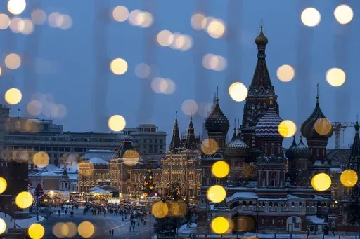 Red Square, the GUM department store, center, and the St. Basil's Cathedral, right, are decorated for the New Year and Christmas festivities are seen through a window of the Hotel Baltschug Kempinski Moscow in Moscow, Russia, on Friday, Dec. 13, 2024. (AP Photo/Alexander Zemlianichenko)