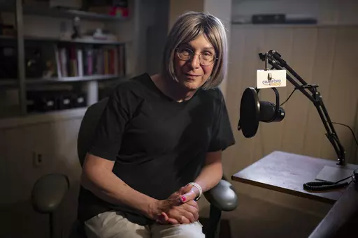 Bernie Wagenblast sits for a photo at her home, Friday, June 16, 2023, in Cranford, N.J. As culture wars erupt anew in the United States over sex and gender, Wagenblast is exchanging that voice for a new one, with a pitch and cadence that reflects a transition from being the man he was to the woman she is becoming. (AP Photo/John Minchillo)