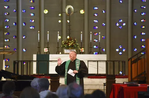 Rev. Chris Morgan leads his congregation at Christ United Methodist Church in Bethel Park Sunday, Oct. 9, 2022. The church has a diverse congregation with most leaning toward the center. In regional gatherings across the country this year, United Methodists approved requests of about 300 congregations to quit the denomination primarily over debates over sexuality and theology. (AP Photo/Philip G. Pavely)